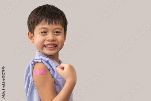 Wallpaper Mural Portrait of happy smile vaccinated little asian kid boy children ages 5 to 11 years old posing show arm with medical plaster after Injection vaccine Covid-19 protection.coronavirus vaccination kid Torontodigital.ca