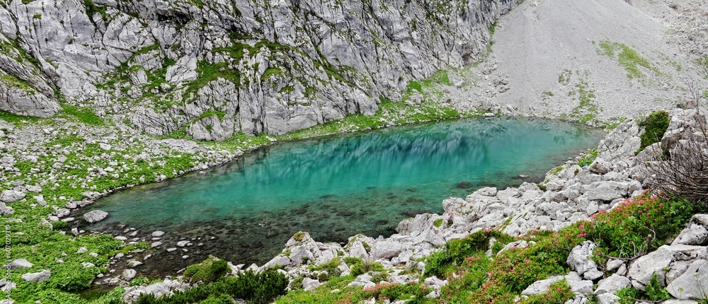 Panoramic shot of a Crystal clear pond surrounded by mountains in Berchtesgaden Bavaria Germany