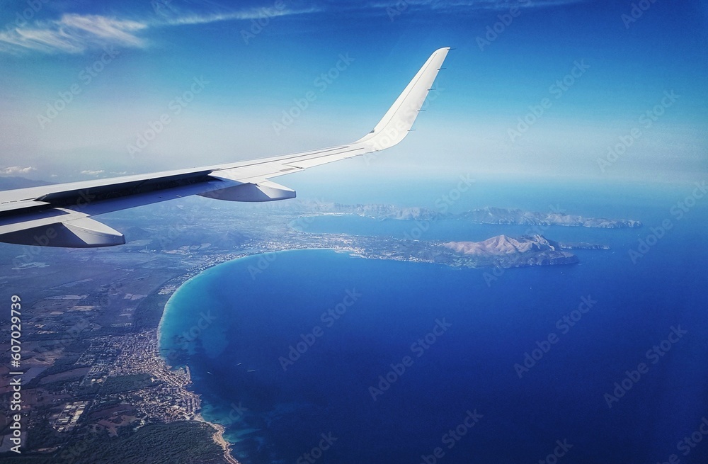 Fototapeta premium Airplane flying over sea