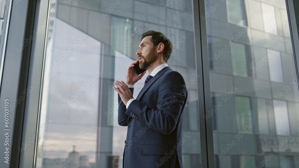 Portrait boss speaking smartphone in office. Businessman using telephone closeup Portrait boss speaking smartphone in office. Businessman using telephone closeup