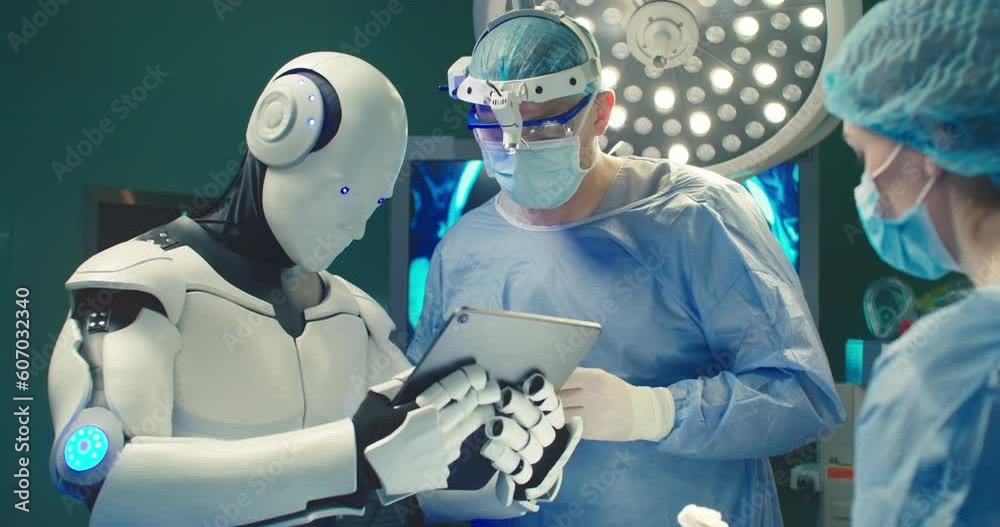 Robot holding digital tablet helps doctor to perform surgical operation in modern hospital. Teamwork of professional medical surgeons in operating room. Concept of modern medicine.