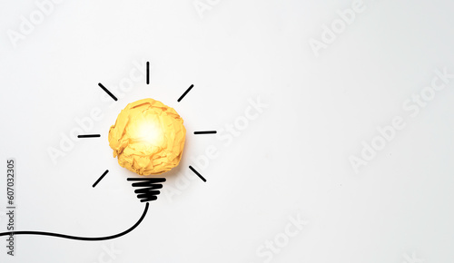 Yellow scrap paper ball with illustration painting for virtual lightbulb. It is creative thinking idea for problem solving and innovation concept.