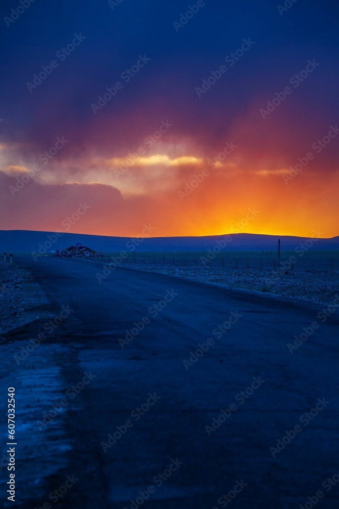 Breathtaking sunset view in the Ali Prefecture in Tibet, China with glowing orange clouds Breathtaking sunset view in the Ali Prefecture in Tibet, China with glowing orange clouds