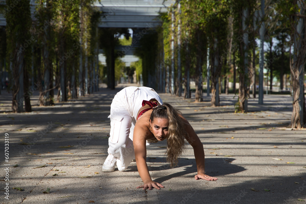 © @skuder_photographer - Latin woman, young and beautiful dancing modern dance in the street in a park and makes different expressions and postures. Concept dance, hip hop, dance, art, action, beauty, youth art. © @skuder_photographer - Latin woman, young and beautiful dancing modern dance in the street in a park and makes different expressions and postures. Concept dance, hip hop, dance, art, action, beauty, youth art.