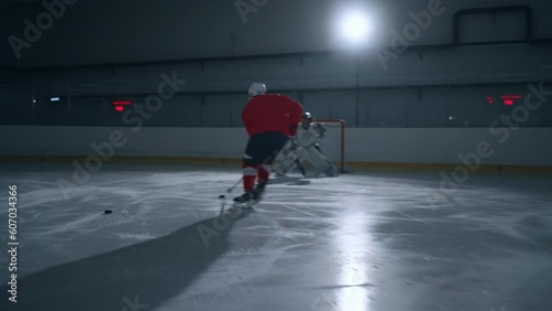Wallpaper Mural Dynamic footage of a hockey player in a red jersey showcasing expert skill, quickly moving across the ice and scoring a goal Torontodigital.ca