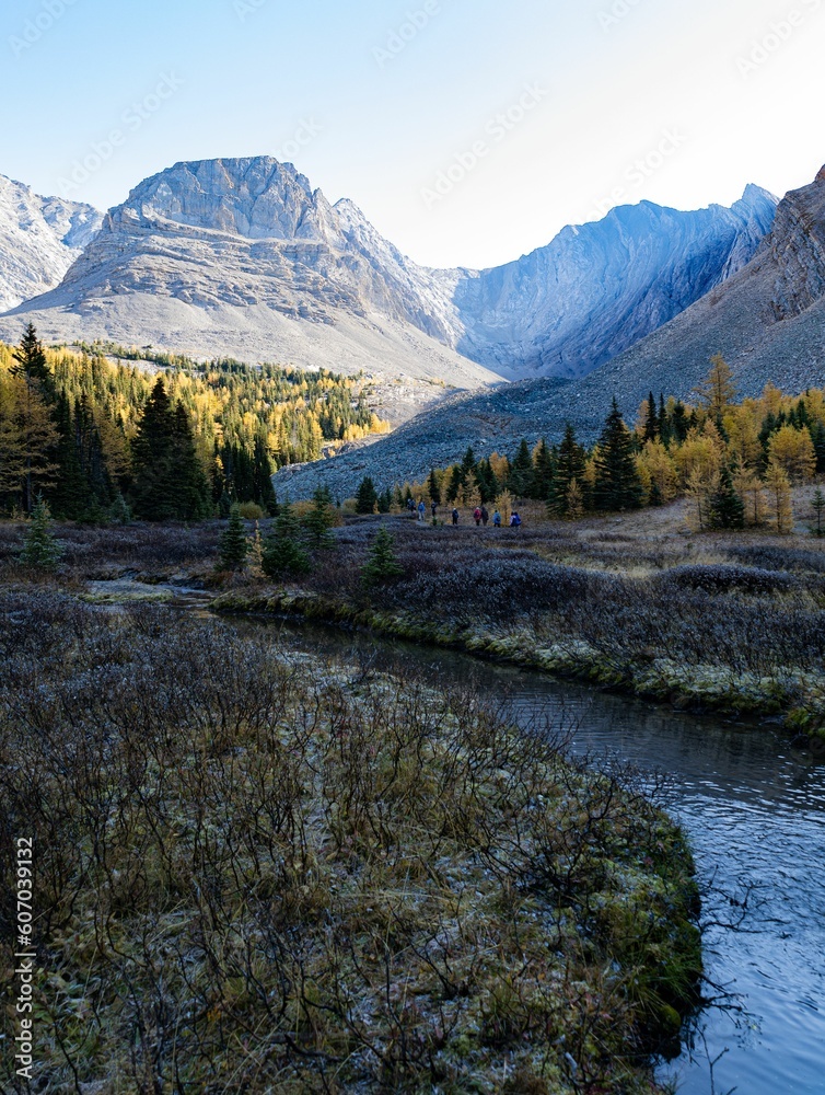 Vertical shot of the mountains in Arethusa Cirque Trail in front of a river in Kananaskis, Canada