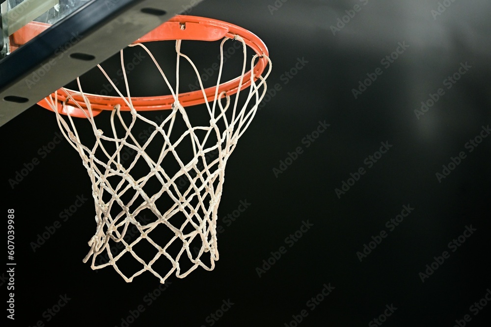 Close-up view of a basketball ring of an indoor stadium before the dark background