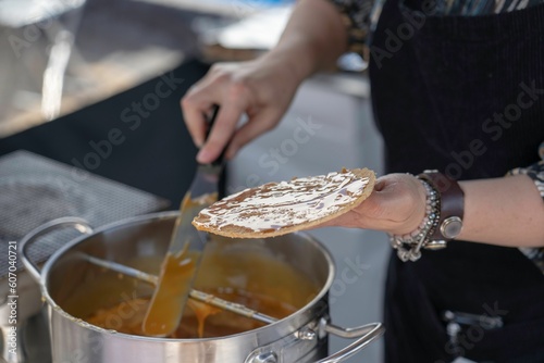 Closeup shot of a person at a local market making traditional dutch stroopwafel waffles