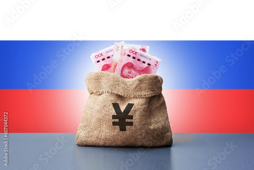 Bag money with chinese yuan banknotes and Russia flag. Concept of economic cooperation between the China and Russia, trading and support, investment photo