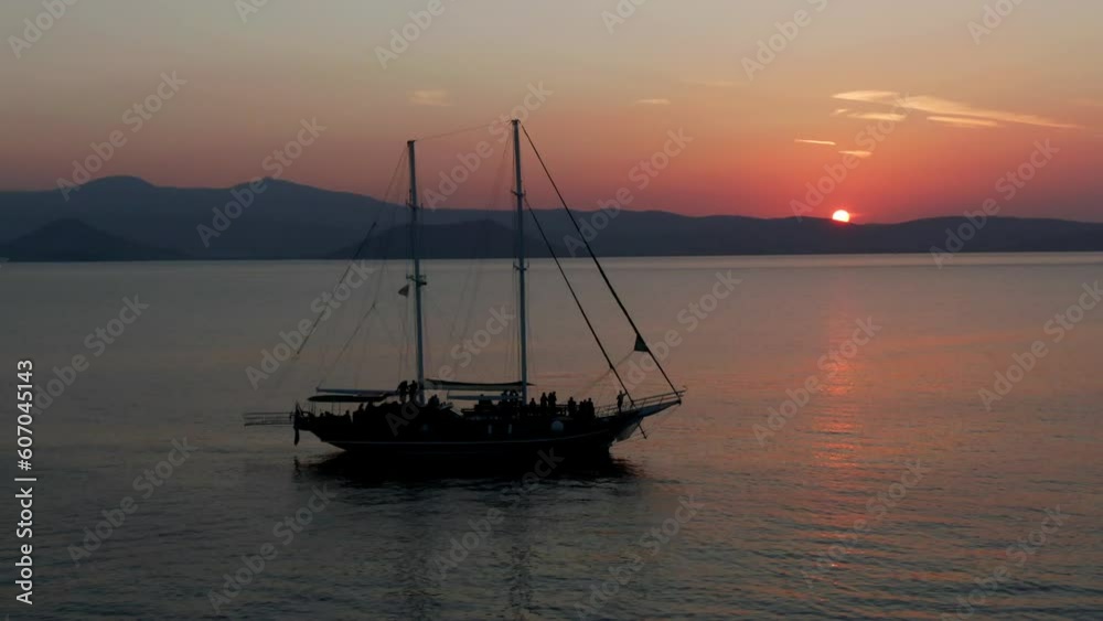 Aerial drone parallax video of old boat on the ocean in colourful sunset Aerial drone parallax video of old boat on the ocean in colourful sunset