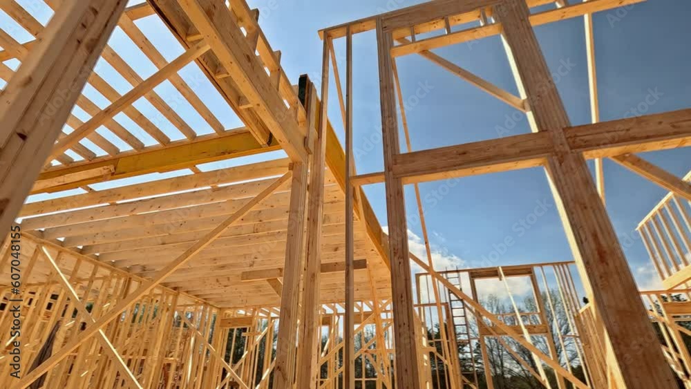 In construction of new home frame house is built with wooden beams sticks In construction of new home frame house is built with wooden beams sticks