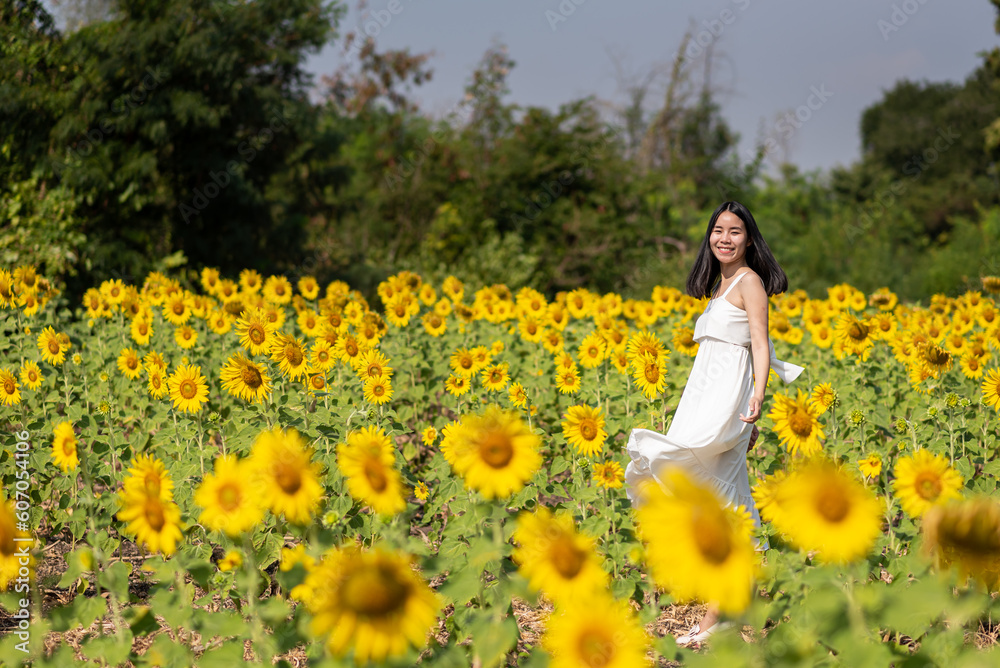 Female tourist feel happy and chilling among sunflowers garden at Thailand Female tourist feel happy and chilling among sunflowers garden at Thailand