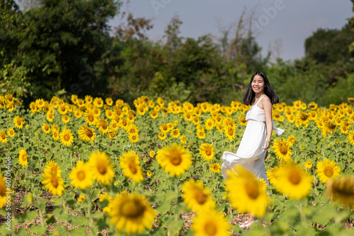 Female tourist feel happy and chilling among sunflowers garden at Thailand