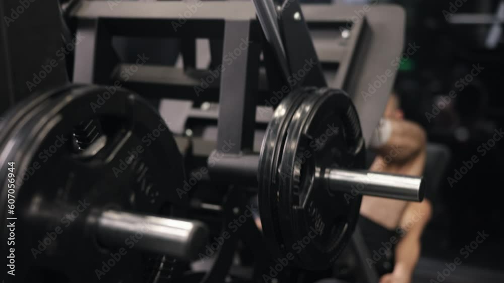 male trainer, Fitness instructor, Targeting leg muscles. Attractive male trainer gym performs leg press exercises. male trainer, Fitness instructor, Targeting leg muscles. Attractive male trainer gym performs leg press exercises.
