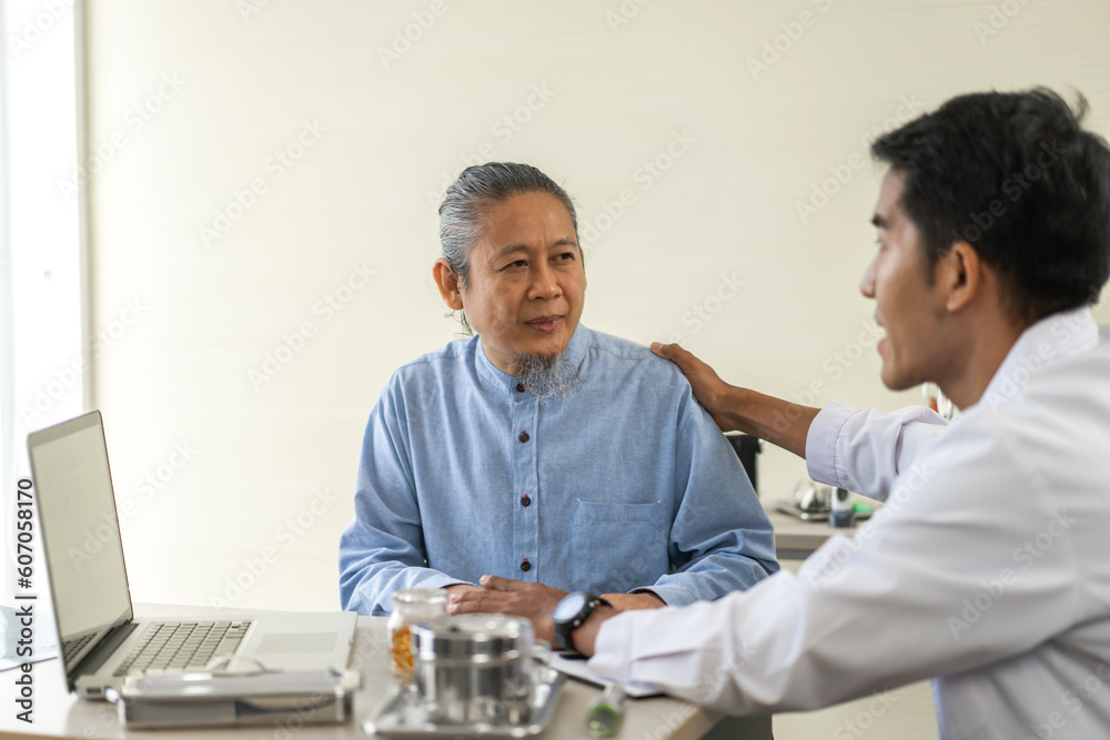 Obraz premium Asian man doctor wearing uniform with stethoscope help discussing and consulting talk to sick senior patient checkup information, support, care, diseases, treatment in hospital.elderly healthcare