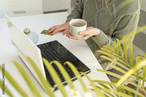 Wallpaper Mural Next to the credit card. A woman makes purchases online Torontodigital.ca
