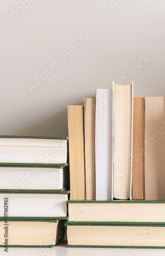 Stacked old books, neutral aesthetic background with copy space