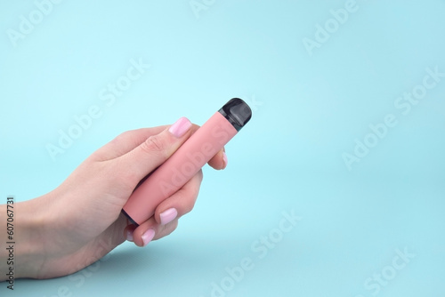 Set of multicolor disposable electronic cigarettes on a blue background.