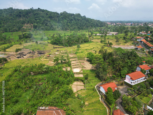 Aerial view of smoky rice fields and slopes around a public recreation area in Subang district, West Java, Indonesia photo