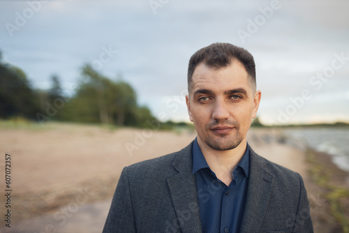 middle-aged white man in business suit outdoor on beach, lifestyle