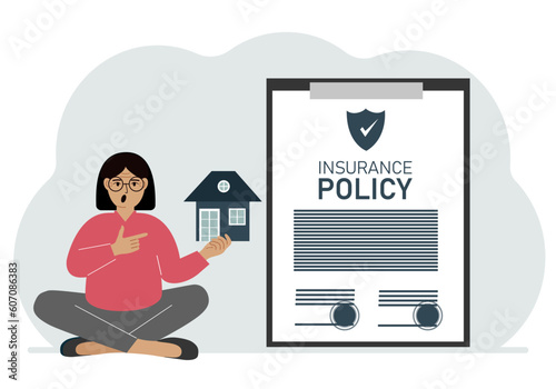 A woman holds in his hands at home next to a large insurance contract. Home and real estate insurance concept.