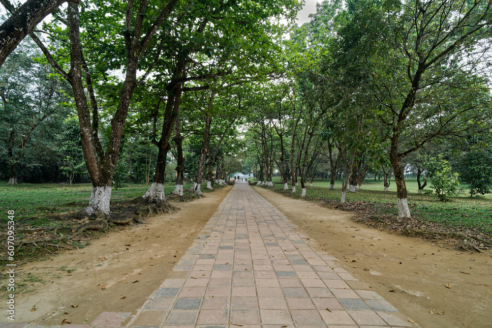 The scenery of the exit from the Emperor Minh Mang Tomb in Hue city, Vietnam, with beautiful green trees and grass that is nice and shady. The scenery of the exit from the Emperor Minh Mang Tomb in Hue city, Vietnam, with beautiful green trees and grass that is nice and shady.