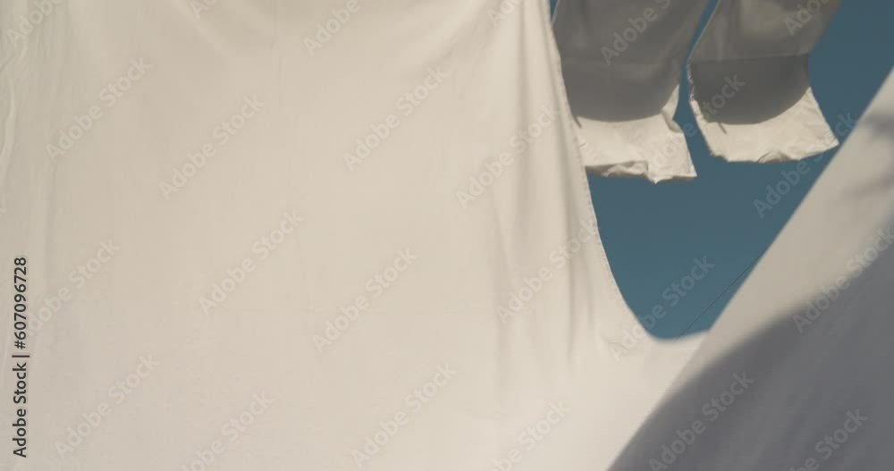 Sheets hanging to dry on a laundry line