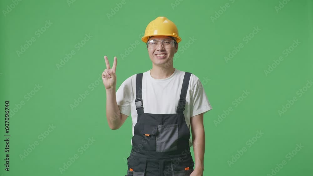Asian Man Worker Wearing Goggles And Safety Helmet Smiling And Showing Peace Gesture To Camera While Standing In The Green Screen Background Studio
Asian Man Worker Wearing Goggles And Safety Helmet Smiling And Showing Peace Gesture To Camera While Standing In The Green Screen Background Studio