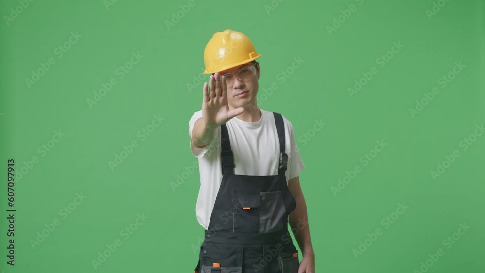 Asian Man Worker Wearing Goggles And Safety Helmet Looking At Camera And Disapproving With No Hand Sign While Standing In The Green Screen Background Studio
Asian Man Worker Wearing Goggles And Safety Helmet Looking At Camera And Disapproving With No Hand Sign While Standing In The Green Screen Background Studio