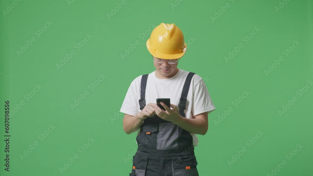 Asian Man Worker Wearing Goggles And Safety Helmet Using Smartphone And Pointing To Side While Standing In The Green Screen Background Studio
Asian Man Worker Wearing Goggles And Safety Helmet Using Smartphone And Pointing To Side While Standing In The Green Screen Background Studio