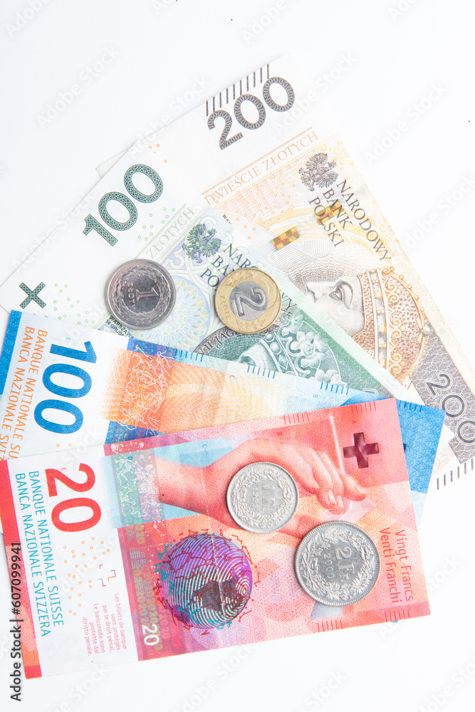 Obraz premium polish zloty currency and swiss francs currency coins and banknotes
