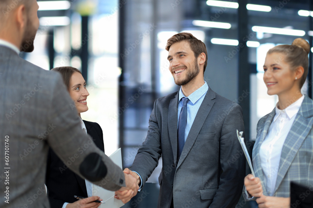 Business partners handshaking over business objects on workplace. Business partners handshaking over business objects on workplace.