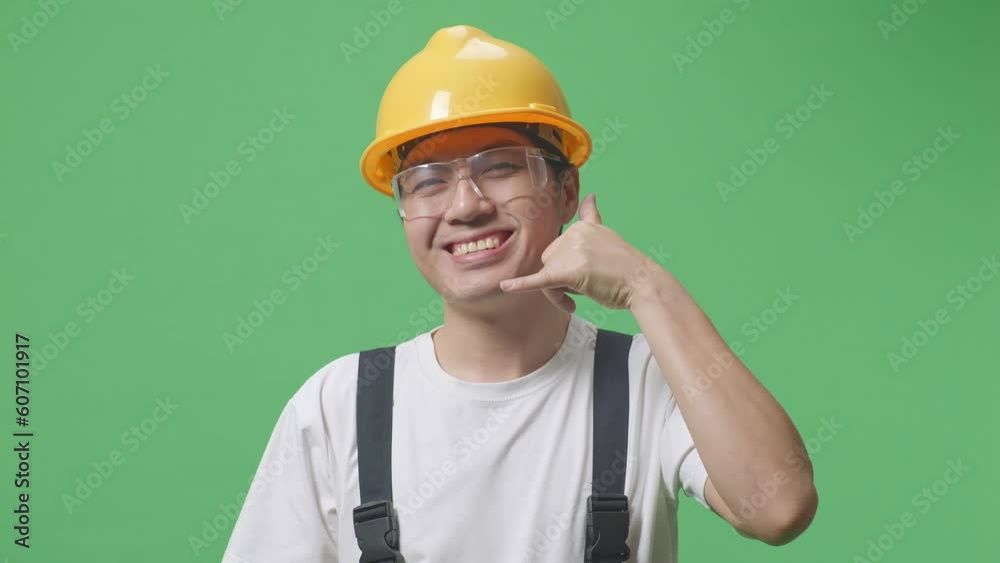 Close Up Of Asian Man Worker Wearing Goggles And Safety Helmet Smiling And Making Call Me Gesture To Camera While Standing In The Green Screen Background Studio
Close Up Of Asian Man Worker Wearing Goggles And Safety Helmet Smiling And Making Call Me Gesture To Camera While Standing In The Green Screen Background Studio