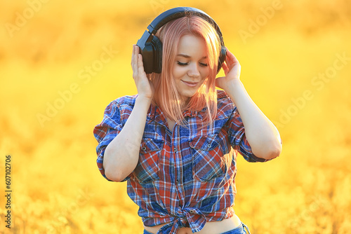 audio headphones summertime girl music in a field of flowers, young female spring
