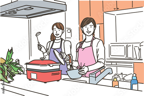 キッチンで料理をするエプロン姿の女性2人