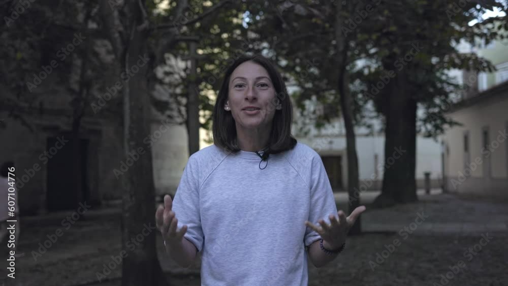 Journalist: the girl looks at the camera, speaks and gesticulates. A woman with a small microphone walks and tells a blog. Journalist: the girl looks at the camera, speaks and gesticulates. A woman with a small microphone walks and tells a blog.