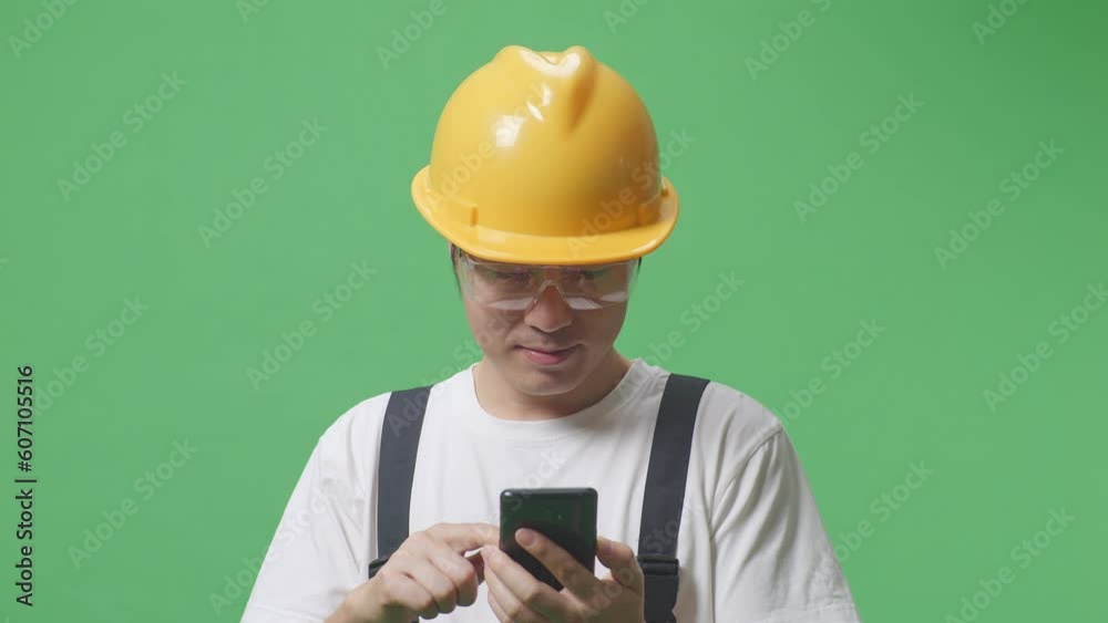 Close Up Of Asian Man Worker Wearing Goggles And Safety Helmet Smiling And Using Smartphone While Standing In The Green Screen Background Studio
Close Up Of Asian Man Worker Wearing Goggles And Safety Helmet Smiling And Using Smartphone While Standing In The Green Screen Background Studio