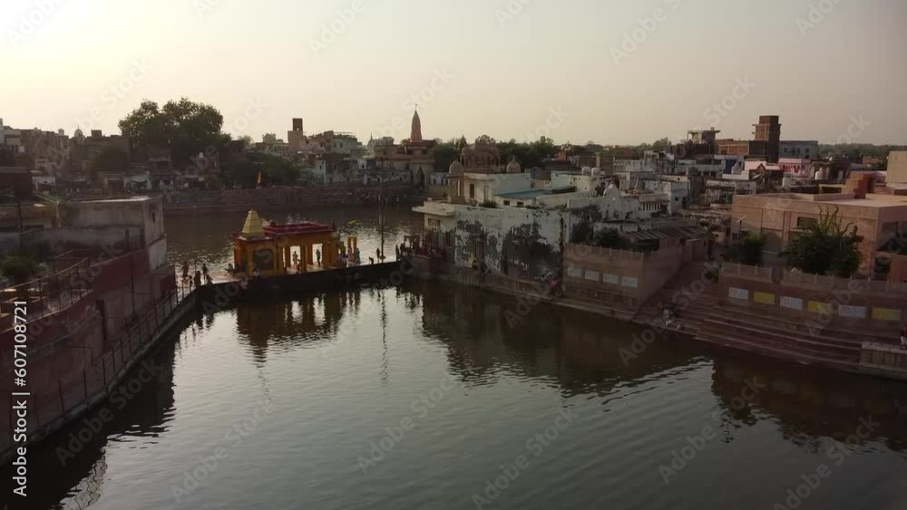 drone filming at sunset, sacred lake shyama kunda on govardhan hill in india, place of pilgrimage, holy place drone filming at sunset, sacred lake shyama kunda on govardhan hill in india, place of pilgrimage, holy place