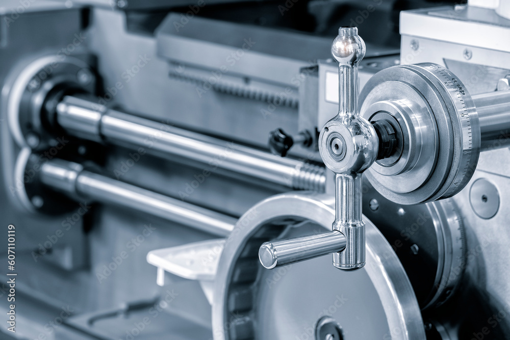 Lathe control knobs close up blue tone. Metal machine tools industry. The metalworking process by turning machine. industry metal processing concept background Lathe control knobs close up blue tone. Metal machine tools industry. The metalworking process by turning machine. industry metal processing concept background