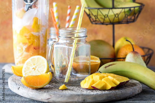 A blender container filled with ingredients used to make a mango citrus smoothie