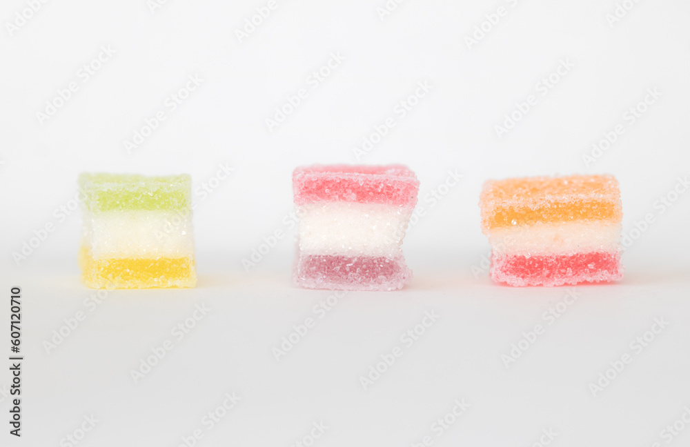 sugar coated jelly with beautiful colors on white background with copy space sugar coated jelly with beautiful colors on white background with copy space