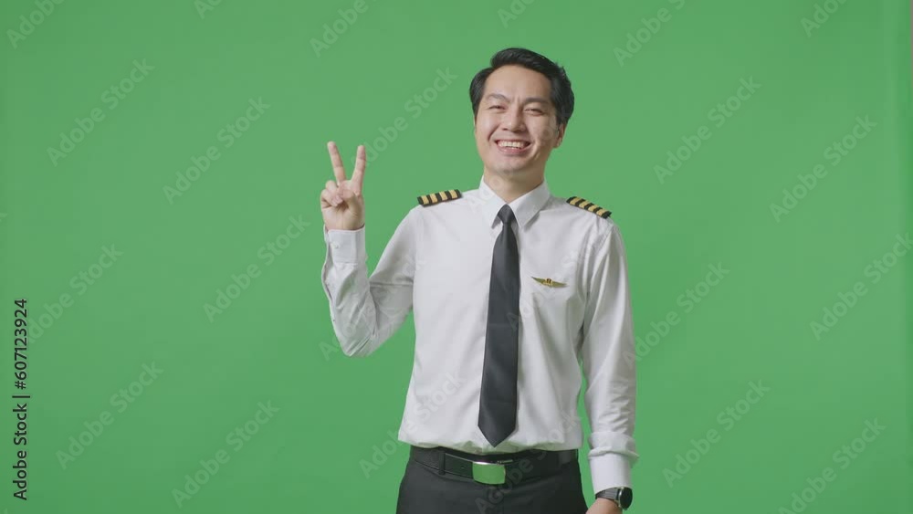 Asian Man Pilot Smiling And Showing Peace Gesture To Camera While Standing In The Green Screen Background Studio
Asian Man Pilot Smiling And Showing Peace Gesture To Camera While Standing In The Green Screen Background Studio