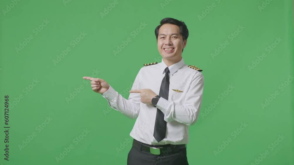 Asian Man Pilot Smiling And Pointing To Side While Standing In The Green Screen Background Studio
Asian Man Pilot Smiling And Pointing To Side While Standing In The Green Screen Background Studio