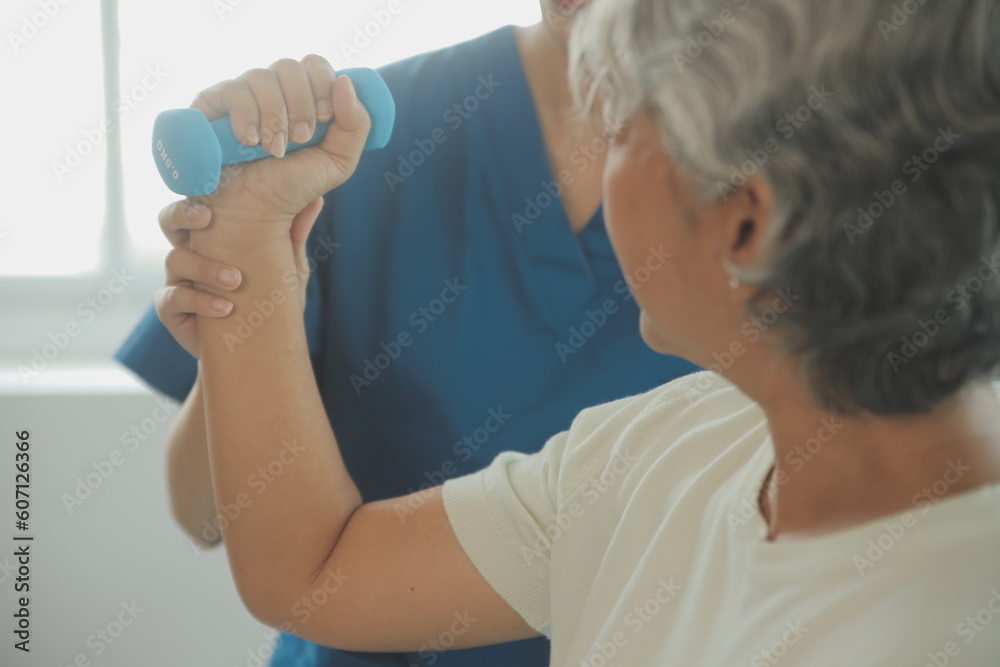 Physiotherapist man giving exercise with dumbbell treatment About Arm and Shoulder of athlete male patient Physical therapy concept