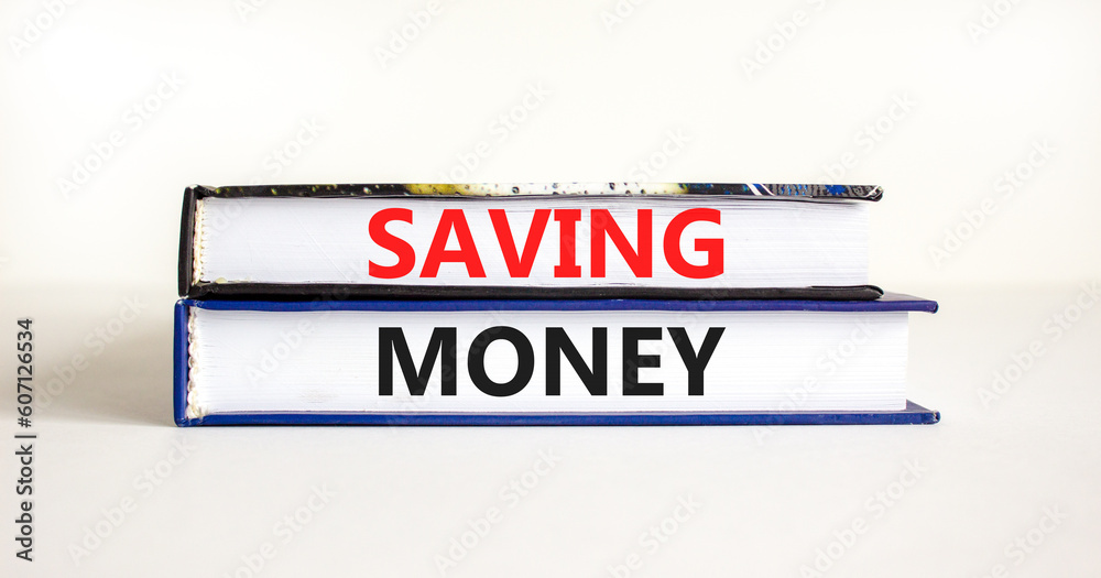 Saving money symbol. Concept words Saving money on beautiful books on a beautiful white table white background. Business, support and saving money concept. Copy space.
