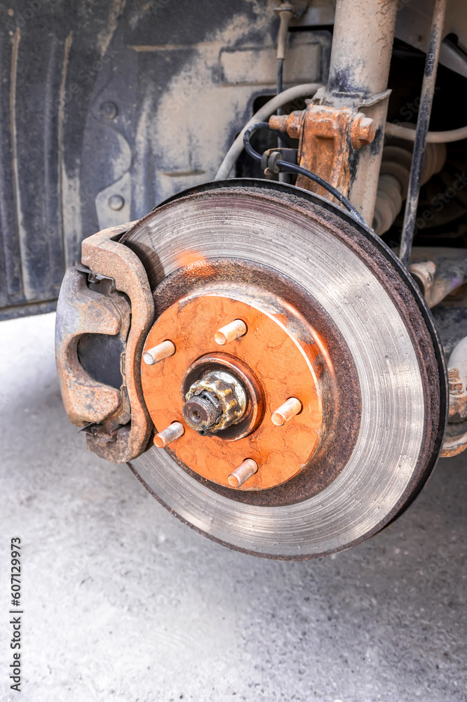 Rusty car brake disc is lubricated with copper grease before installing a car wheel