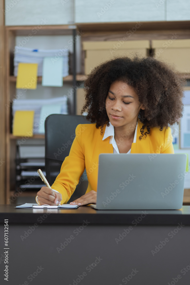 African American businesswoman using laptop computer at office workplace. African American businesswoman using laptop computer at office workplace.
