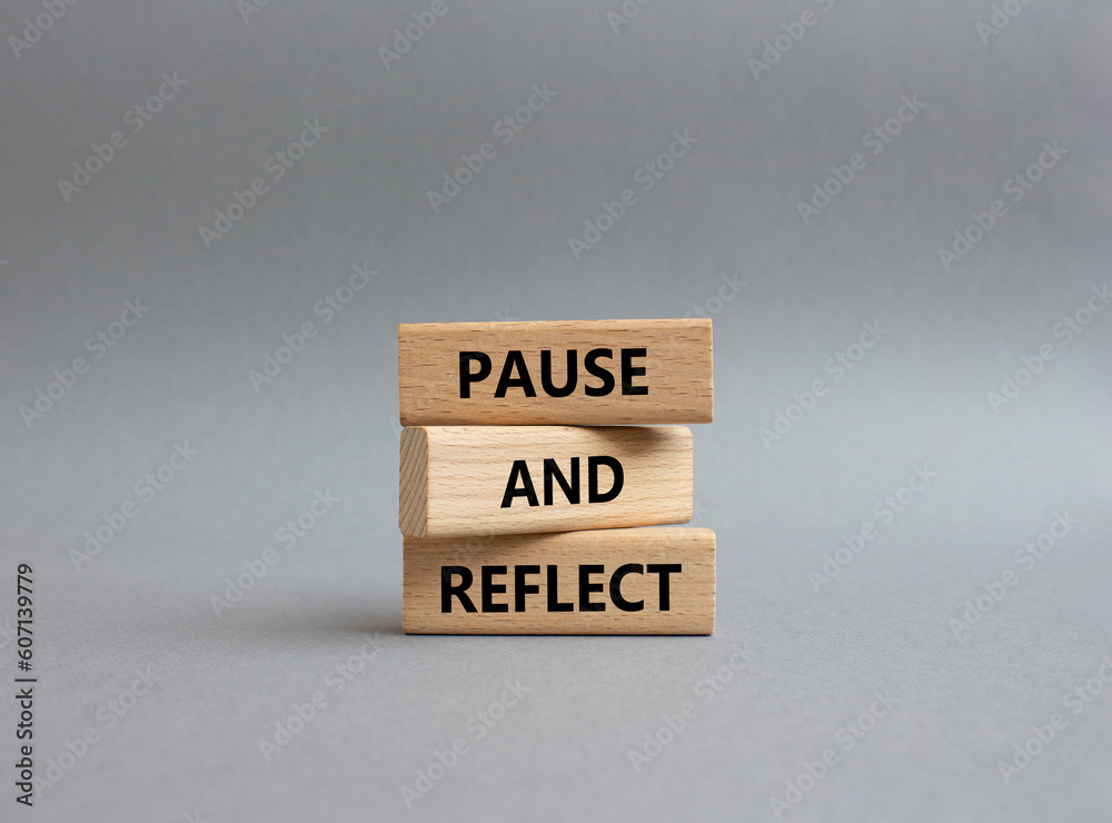 Pause and Reflect symbol. Concept words Pause and Reflect on wooden blocks. Beautiful grey background. Business and Pause and Reflect concept. Copy space. Pause and Reflect symbol. Concept words Pause and Reflect on wooden blocks. Beautiful grey background. Business and Pause and Reflect concept. Copy space.