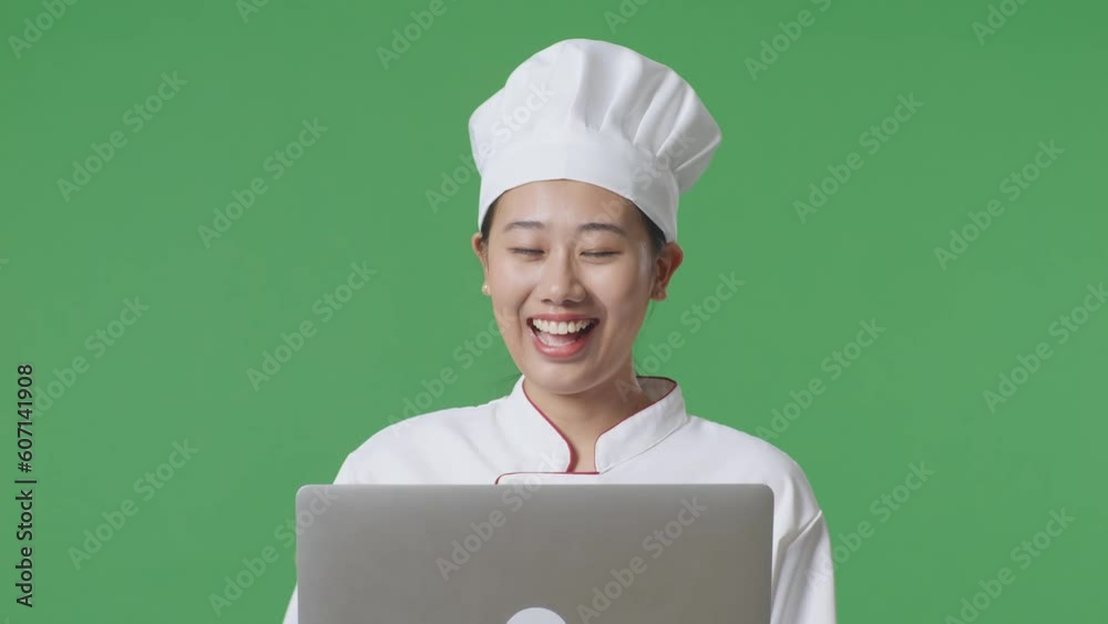 Close Up Of Asian Woman Chef Using A Laptop And Pointing To Side While Standing In The Green Screen Background Studio
Close Up Of Asian Woman Chef Using A Laptop And Pointing To Side While Standing In The Green Screen Background Studio