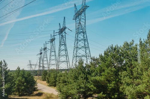 Row of High Voltage Power Poles in a White Day Field